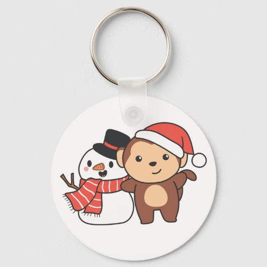冬に雪だるまを持つ猿のクリスマスキーチャ キーホルダー (正面)