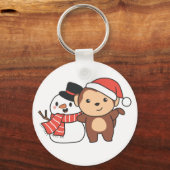冬に雪だるまを持つ猿のクリスマスキーチャ キーホルダー (正面)