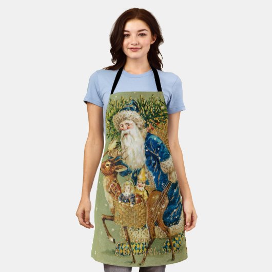 冬の雪の中で鹿とクリスマスプレゼントを持つサンタ エプロン (着用した状態)