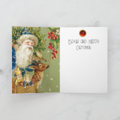 冬の雪の中で鹿とクリスマスプレゼントを持つサンタ シーズンカード (内部)