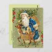 冬の雪の中で鹿とクリスマスプレゼントを持つサンタ ポストカード (正面/裏面)
