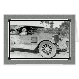 古い車の白黒写真。ダックスフントの運転