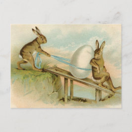 古く旧式なヴィンテージのハッピーイースターのウサギおよび卵 シーズンポストカード