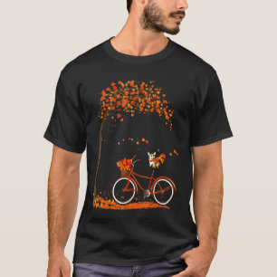 可愛いコーギーが自転車に乗っている秋の女性 Tシャツ