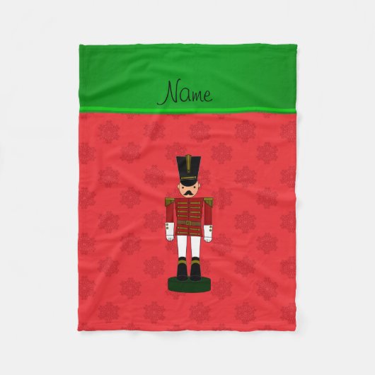 名前のパーソナライズされたくるみ割り赤い雪片 フリースブランケット (正面)