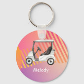 名前の付いたピンクのカラフル背景のゴルフカート キーホルダー (正面)
