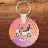 名前の付いたピンクのカラフル背景のゴルフカート キーホルダー (正面)