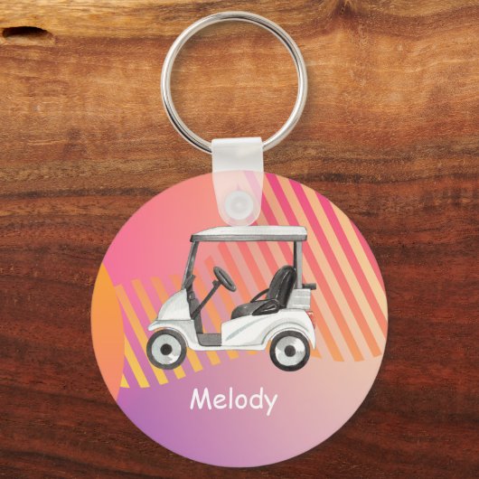 名前の付いたピンクのカラフル背景のゴルフカート キーホルダー (正面)