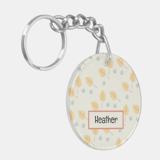 名前をカスタムするオレンジ色の熱帯葉性クリーム キーホルダー (正面左)