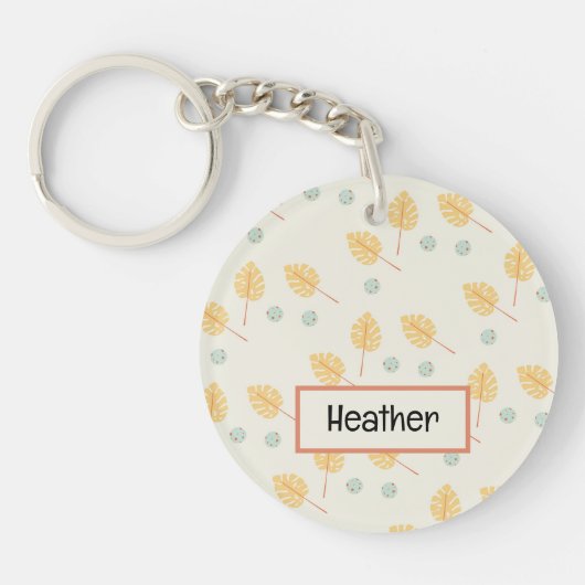 名前をカスタムするオレンジ色の熱帯葉性クリーム キーホルダー (正面)