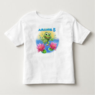 名前入りな跳躍のカエルの男の子のTシャツの誕生日 トドラーTシャツ