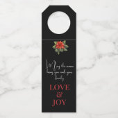 喜びの知らせ赤いクリスマスポインセチアの黒 ボトルネックタグ (裏面)