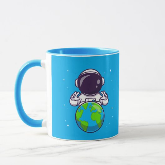 地球を抱える平和な宇宙飛行士 マグカップ (左)