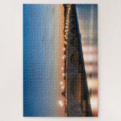 夕暮れ時に広い川に架かる道路橋 ジグソーパズル (縦)