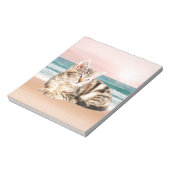 夕焼けでストライプのビーチに座る可愛い猫 ノートパッド (回転)