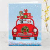 大きな丹犬がサンタクロースと一緒に車の中にいる カード (黄色い花)