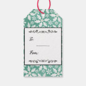 大きな白い雪の結晶が降る緑の背景 ギフトタグ (裏面)