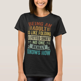 大人になるとは、フィットシートを折りたたむようなもの 2 Tシャツ