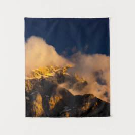 太陽が雲に覆われた山に照らされた タペストリー