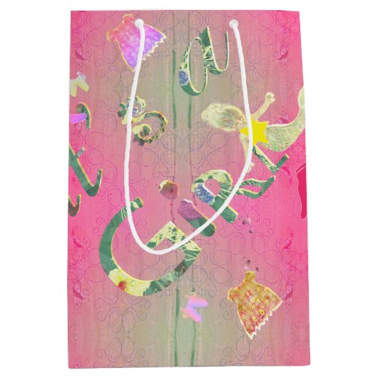 「女の子だ」ピンク図解入りの、写真付きのフローラフォント ミディアムペーパーバッグ (正面)