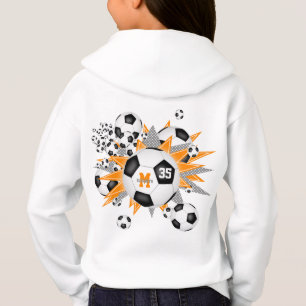 女の子サッカーボールがオレンジ色の灰色の星を吹き出す