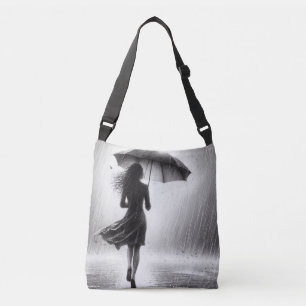 . .女性の歩くが雨の中を傘で鋭く クロスボディバッグ