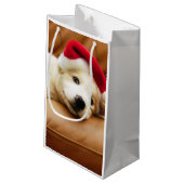 子犬はソファーにクリスマスの帽子そしてあることを身に着けています スモールペーパーバッグ (裏面アングル)