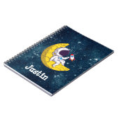 宇宙飛行士が月でロケットと一緒に ノートブック (左側)