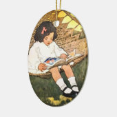 小さな女の子読がハンモックに入っている セラミックオーナメント (左)
