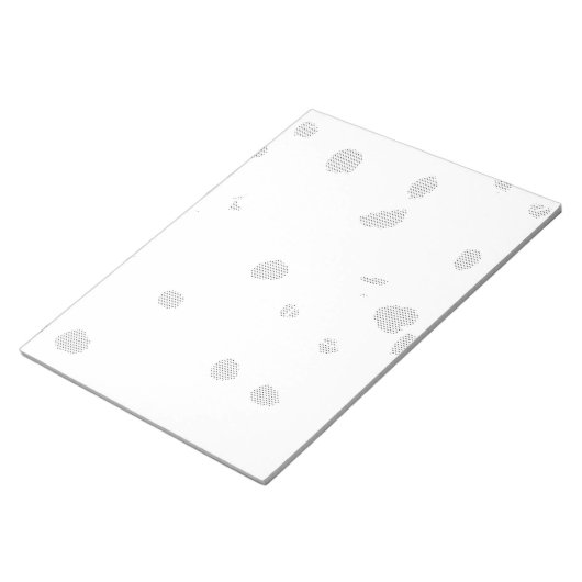 小さな点をたくさん持つ白い背景 ノートパッド (アングル)