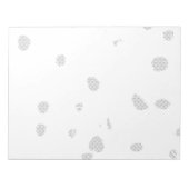 小さな点をたくさん持つ白い背景 ノートパッド (正面)