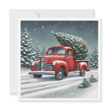 小さな赤いトラックがクリスマスツリーを運ぶ