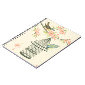 小さな鳥が枝に止まり鳥籠に止まる ノートブック (左側)