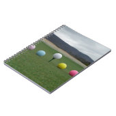 山の上の明るい色のゴルフボール ノートブック (左側)