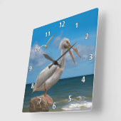 岩の上の白いペリカン スクエア壁時計 (傾斜)