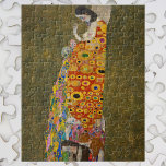 『希望II』（1907/08） by Gustav Klimt、ヴィンテージ アール・ヌーヴォー ジグソーパズル<br><div class="desc">『希望II』（1907/08） by Gustav Klimt は、ビクトリア時代のシンボリズムを特徴とするヴィンテージ絵画で、妊婦が大きな腹を見下ろしながら、人間の頭蓋骨の方を向いている。彼女の足元には、彼女の着物の複雑な模様に織り込まれた3人の女性がいる。女性は胸を露出し、PG-13指定とされている。
アーティストについて:
グスタフ・クリムト（1862-1918）は、オーストリアのシンボリスト画家で、ウィーンのアール・ヌーヴォー運動の最も著名なメンバーの一人である。</div>