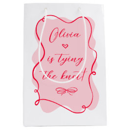 彼女はレトロピンクと赤の結び目を結んでいるブライダル ミディアムペーパーバッグ