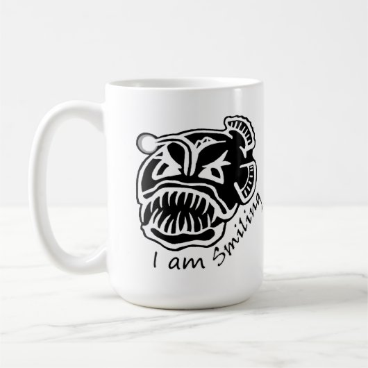 微笑むアンコウです コーヒーマグカップ (左)
