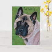 悲しげな表情をした黒犬ことわざごめんなさい カード (黄色い花)