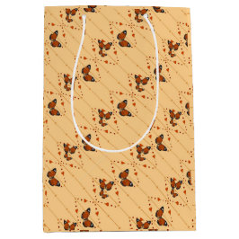 愛と蝶のオレンジ色の対角線 ミディアムペーパーバッグ