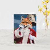 愛らしいクリスマスの赤い狐がサンタの服を着て歌う カード (黄色い花)
