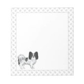 手を使った白黒のパピヨンの漫画の犬 ノートパッド (正面)