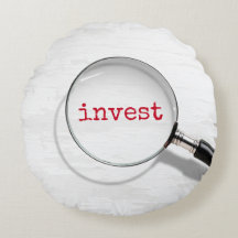 拡大鏡の下の「Invest」テキスト