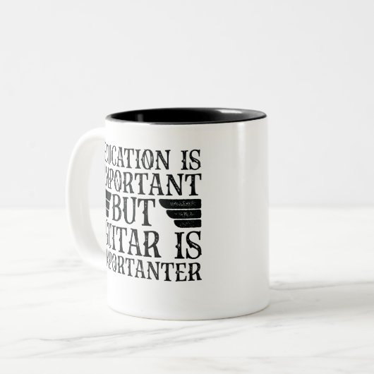 教育は重要だがギターは重要だ ツートーンマグカップ (正面左)