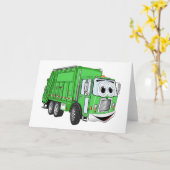 明るい緑の笑顔のごみトラックの漫画 カード (黄色い花)