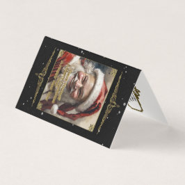 楽しいクリスマスの折り畳みカードを持っている