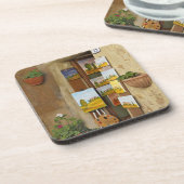 歩道で販売するアートワークを持つ小さな買い物 コースター (左側)
