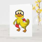 水泳リングとダイビングゴーグルをつけた水泳のカモ カード (黄色い花)