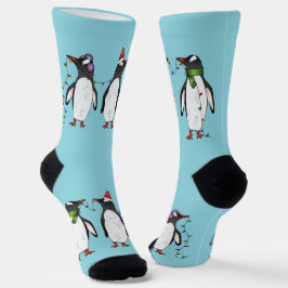 水色の背景にいる3羽のクリスマスのペンギン ソックス