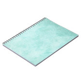 淡いブルーの緑の水彩画の紙の背景のブランク ノートブック (左側)